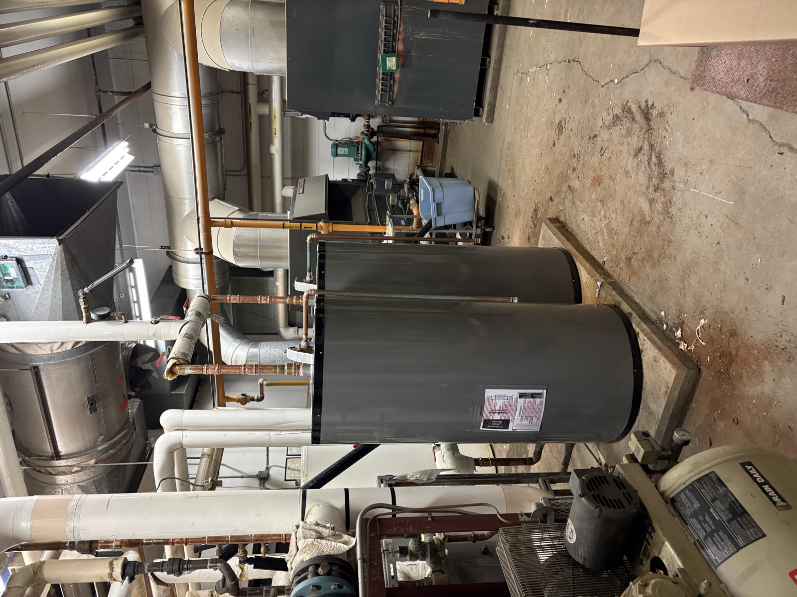 Real Thomas Plumbing job. Commercial mechanical room with hot water tanks and copper supply piping on a North Bay property serviced by Tyler Thomas.