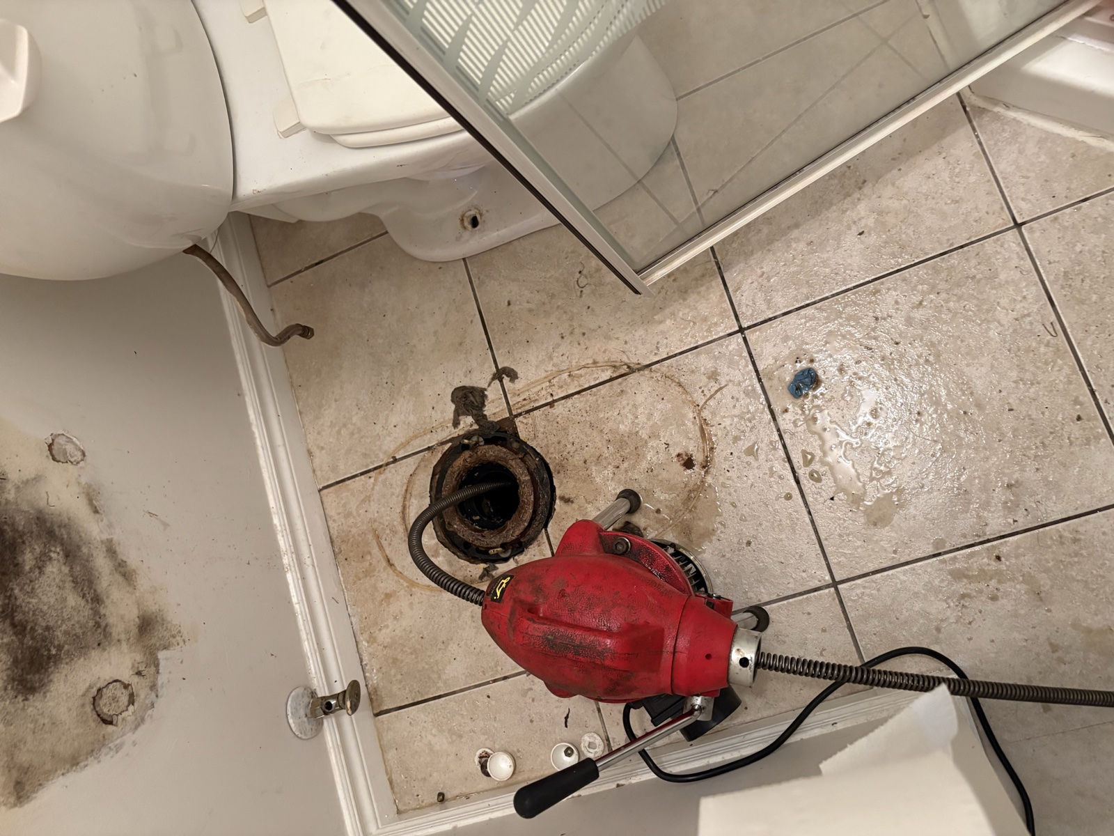 Real Thomas Plumbing job. Tyler running a power drain snake through an open toilet flange on a North Bay drain cleaning call.