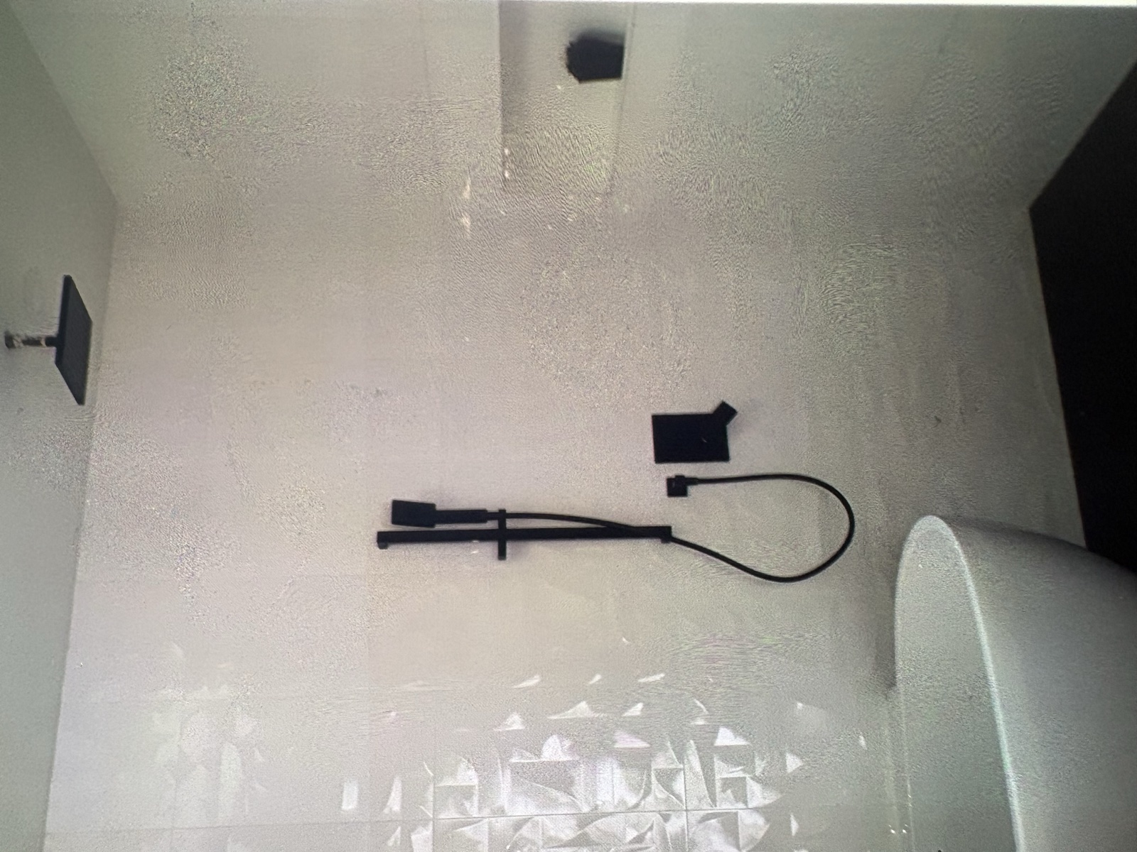 Real Thomas Plumbing job. Finished modern shower with matte-black valve, rain head, and handheld wand installed in a North Bay bathroom renovation by Tyler Thomas.