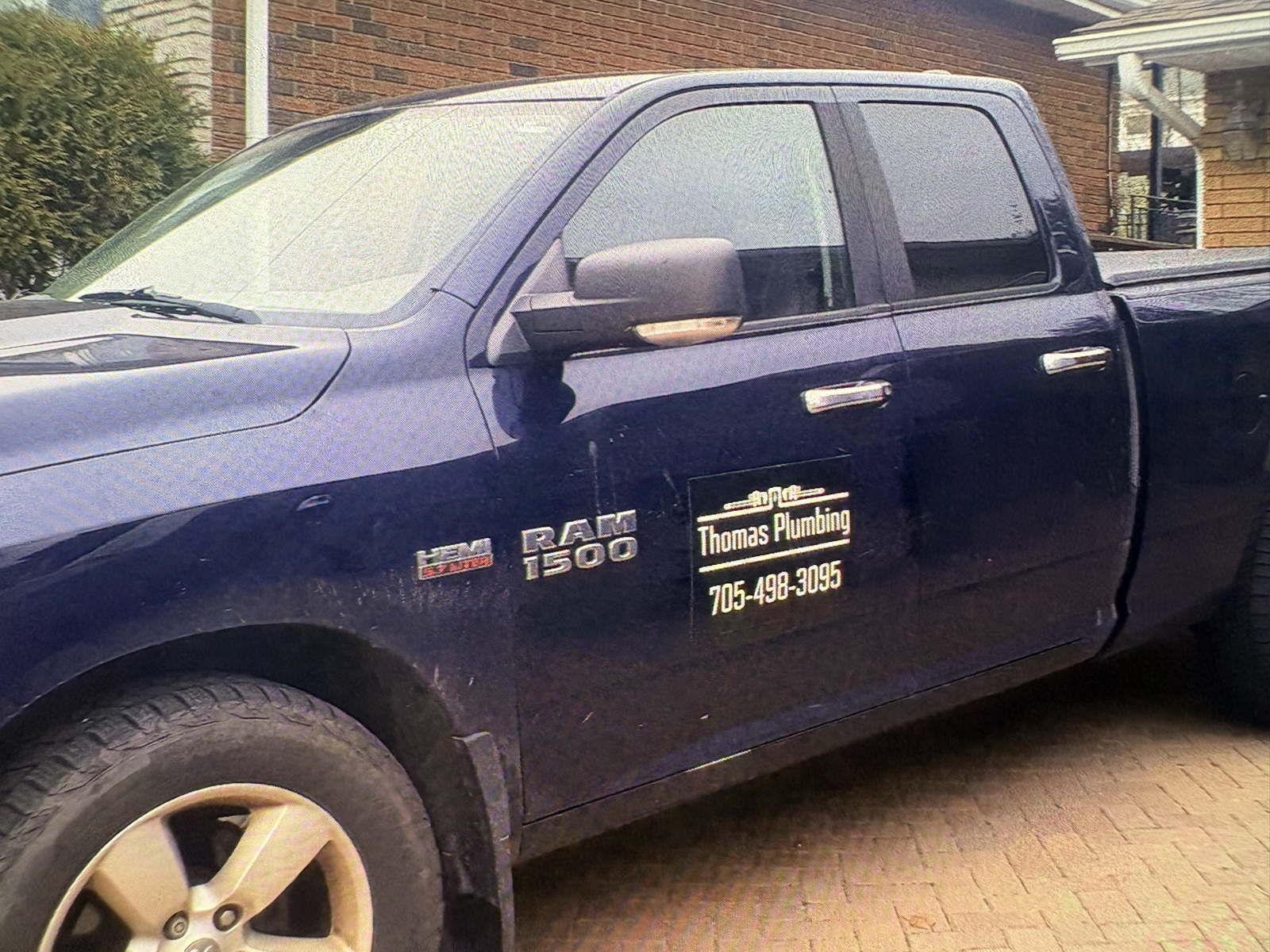 Real Thomas Plumbing service truck with company decal and phone number, on a same-day emergency call in North Bay, Ontario.